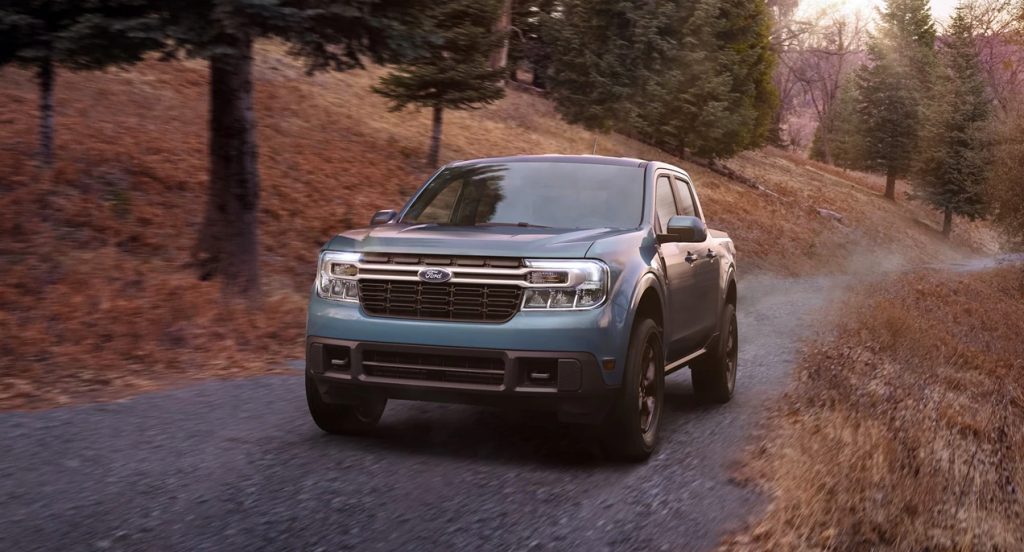 A blue 2022 Ford Maverick small pickup truck is driving off-road.