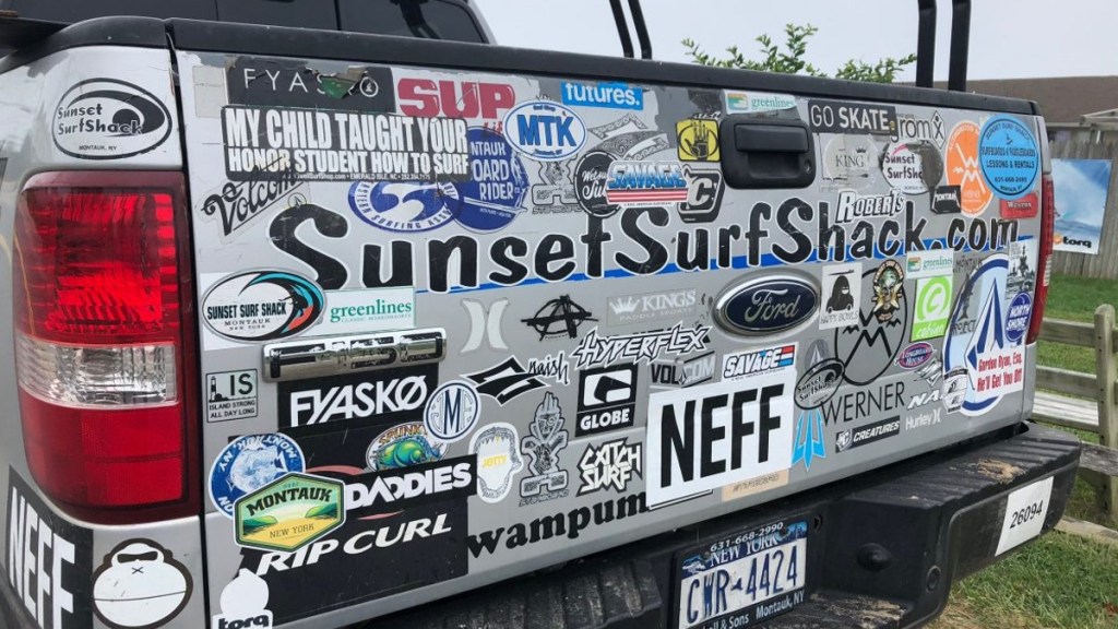 Ford truck with many bumper stickers, highlighting things that lower the resale value of a car