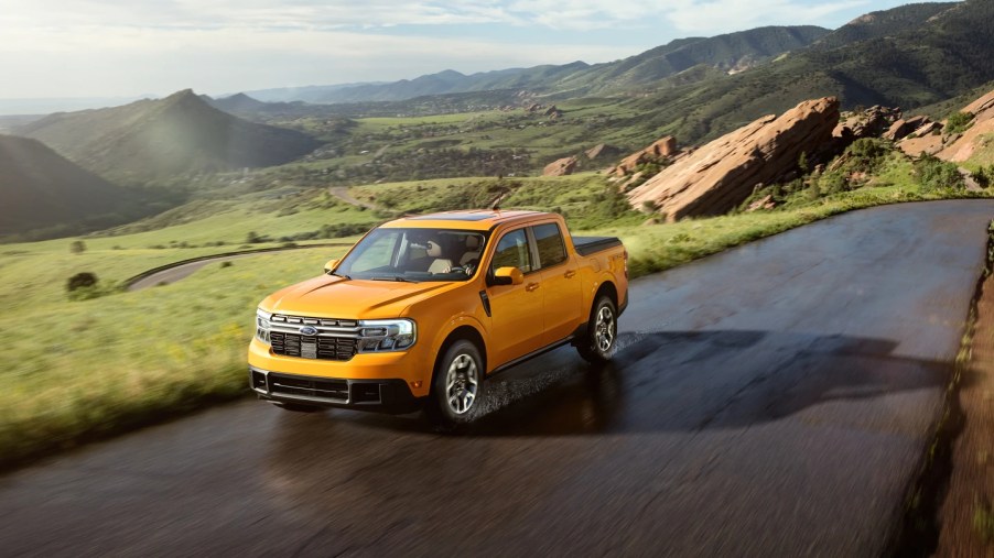 A yellow 2022 Ford Maverick cruises a scenic route as a small truck.