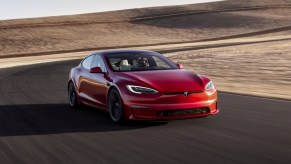 Front angle view of red Tesla model S Plaid, a fast car with one of the quickest quarter-mile acceleration time