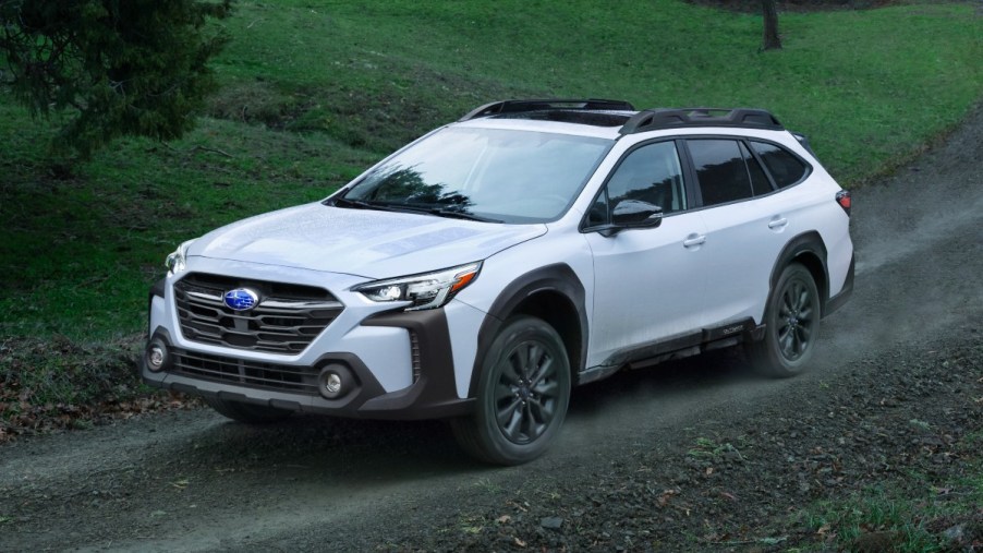 Front angle view of white 2023 Subaru Outback, highlighting its release date and price