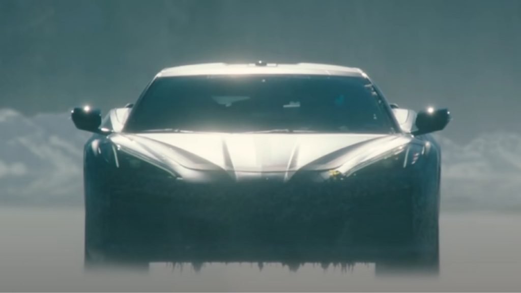 Front view of camouflage-wrapped 2023 Chevy Corvette E-Ray, highlighting its release date and price