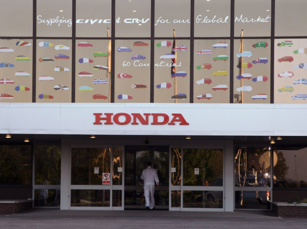 A worker walking into the Honda factory.