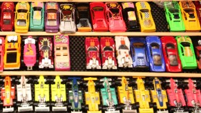 Hot Wheels toy cars displayed on a shelf, highlighting live-action Hot Wheels movie produced by J.J. Abrams' Bad Robot