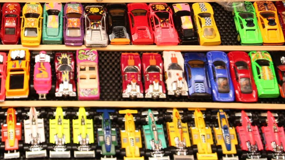 Hot Wheels toy cars displayed on a shelf, highlighting live-action Hot Wheels movie produced by J.J. Abrams' Bad Robot
