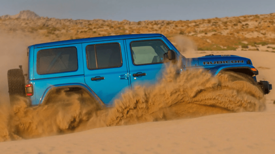 The Jeep Wrangler Rubicon 392 off-road all-terrain SUV driving through sand dunes
