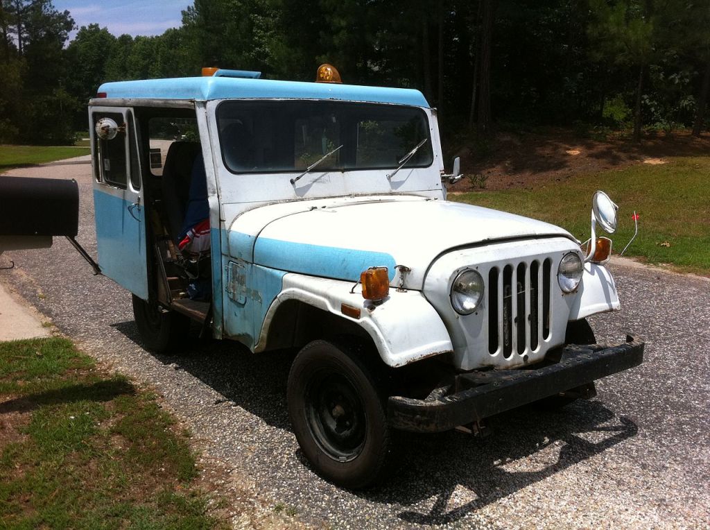 A Jeep mail truck is on display as a delivery vehicle. 