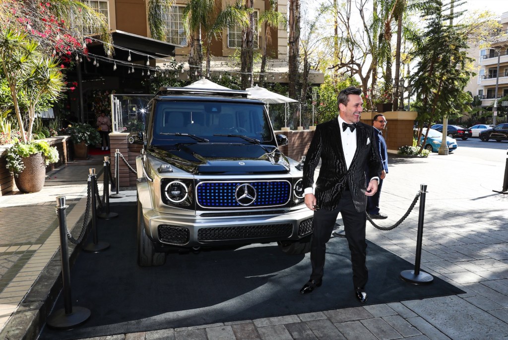 Mercedes brand ambassador Jon Hamm poses with the EQG electric concept vehicle.
