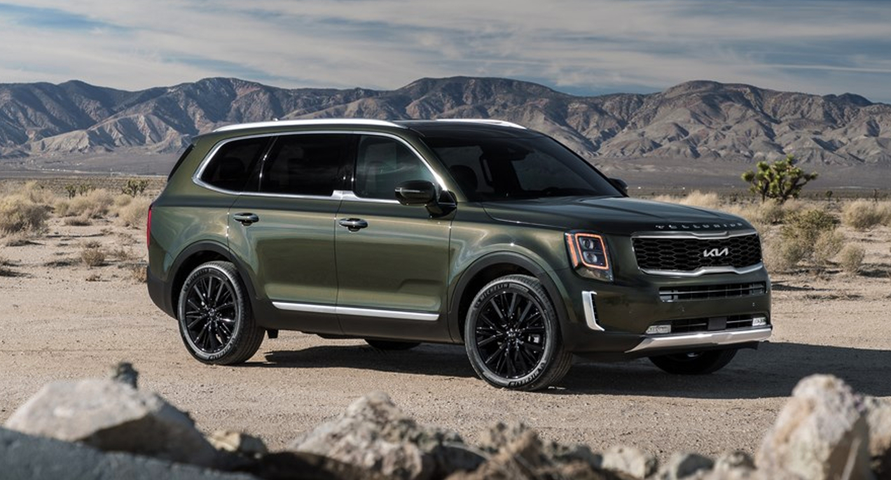 A green 2022 Kia Telluride is parked outdoors.