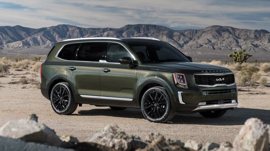 A green 2022 Kia Telluride is parked outdoors.