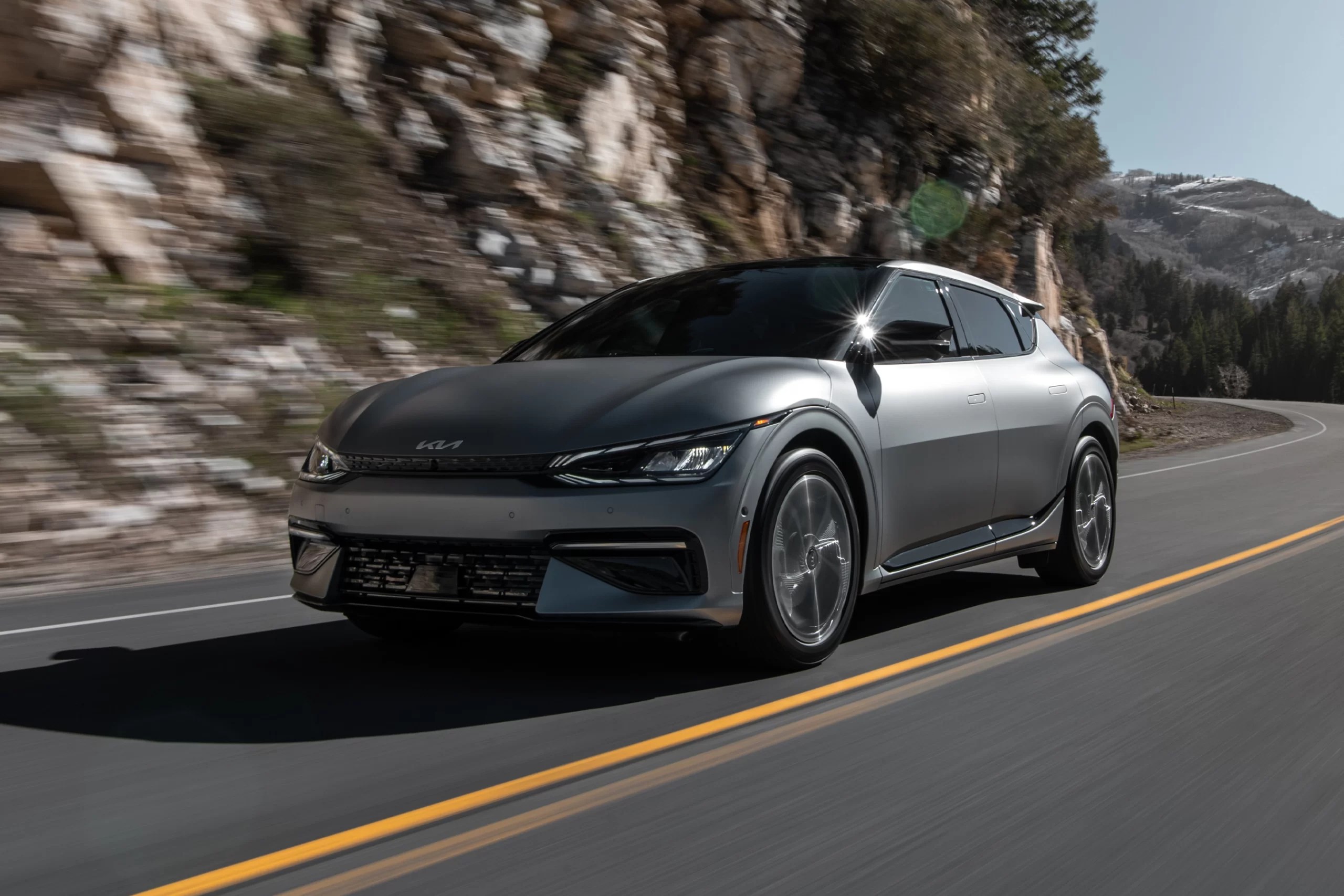 A silver 2022 Kia EV6 navigates a remote road.