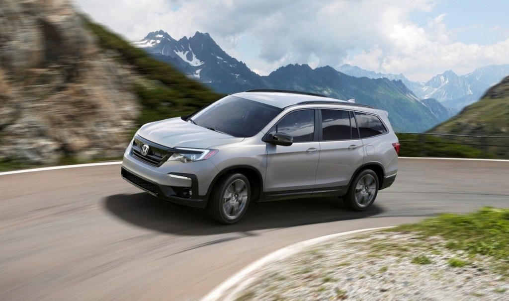 Lunar Silver Metallic 2022 Honda Pilot driving on a mountain road