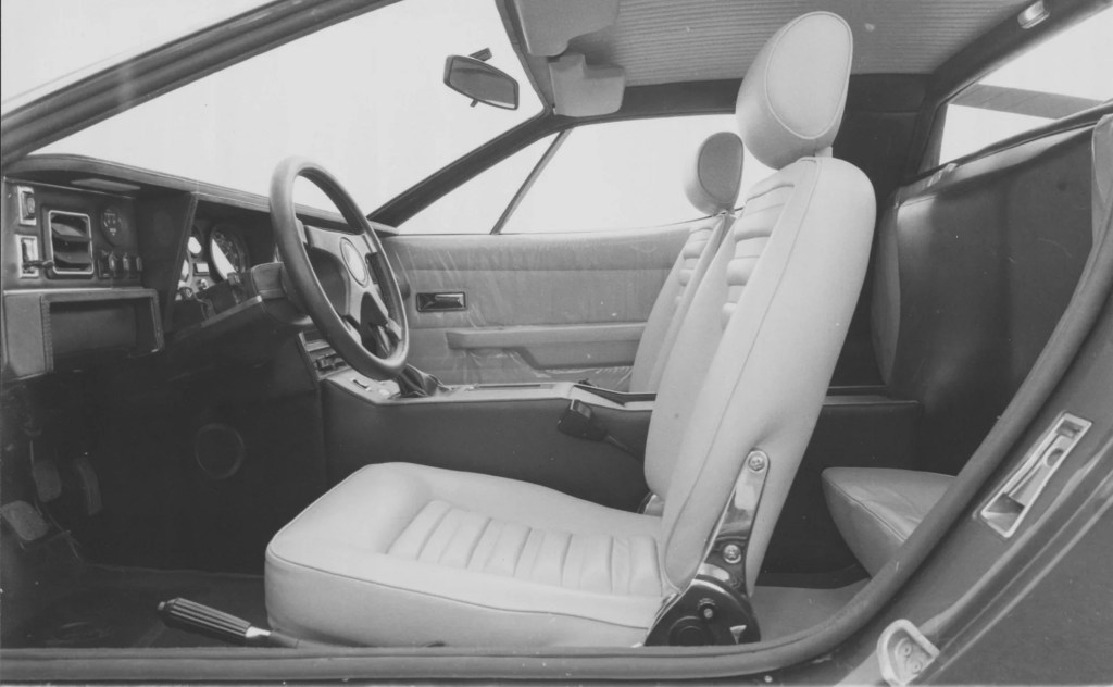 A black-and-white photo of a Maserati Merak's leather seats and dashboard