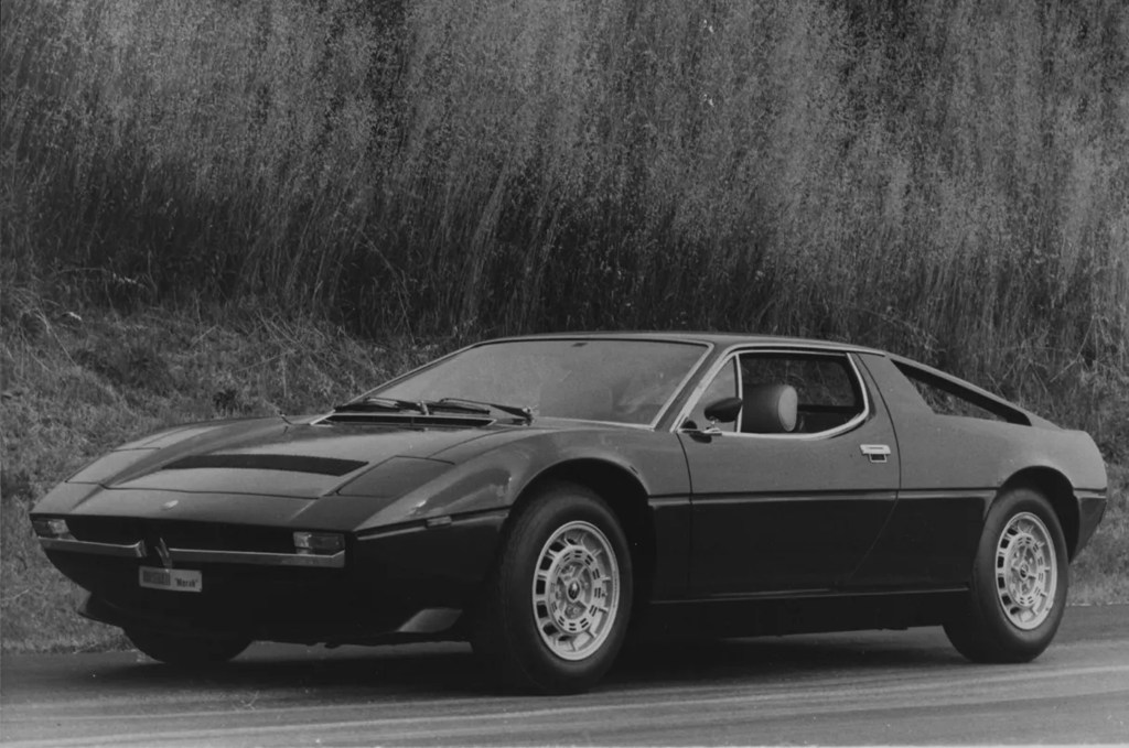 A black-and-white photo of a Maserati Merak on the road