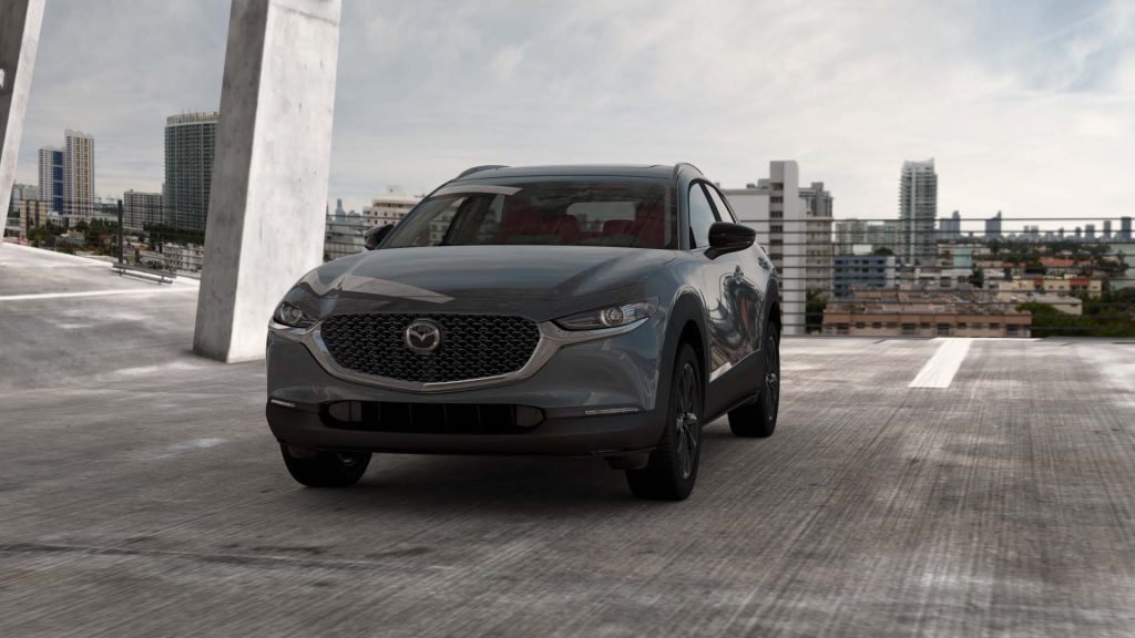 A grey 2022 Mazda CX-30 is shown with an urban view in the background.