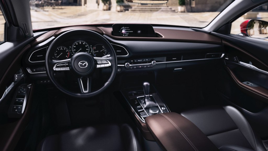 The interior of the Mazda CX-30 crossover is shown. It has leather upholstery with brown accents.