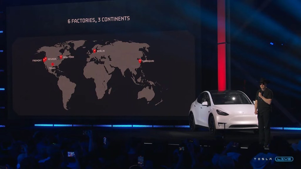 A white Tesla Model Y on stage. 