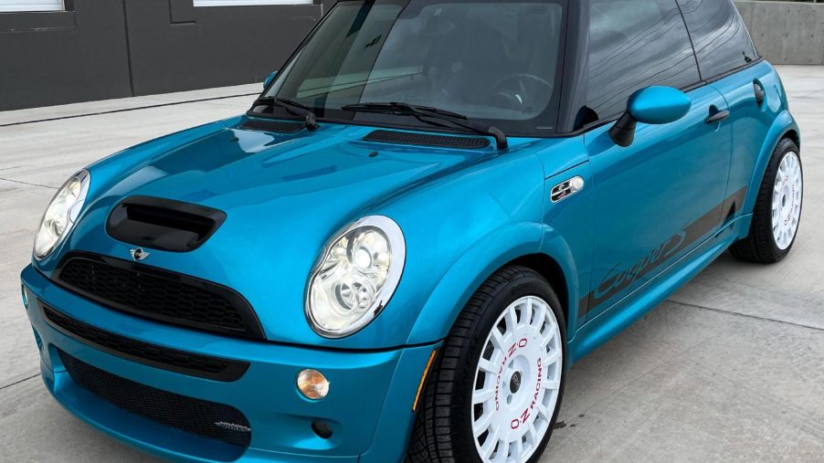 A blue modified 2005 Mini Cooper S with JCW kit in a parking lot