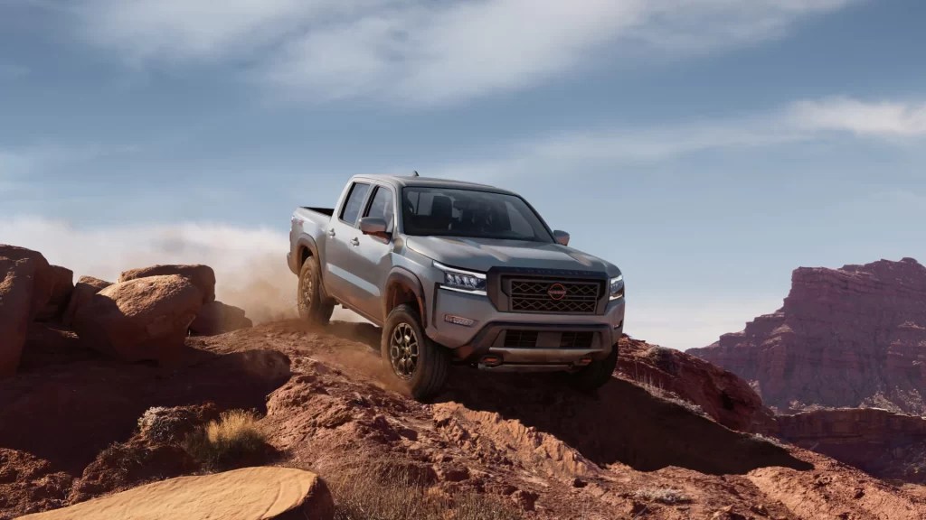 A 2022 Nissan Frontier navigates a desert trail as a mid-size truck.