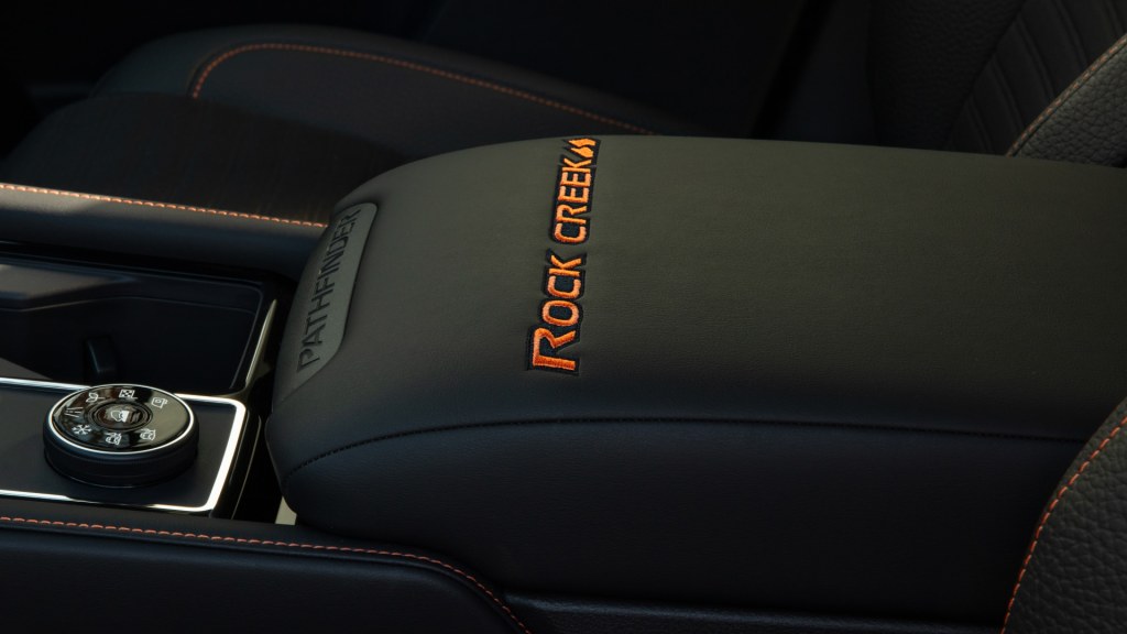The interior of the Nissan Pathfinder Rock Creek, it has unique badges and orange accents.