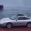 Silver Porsche 996 911 Targa driving in front of the ocean