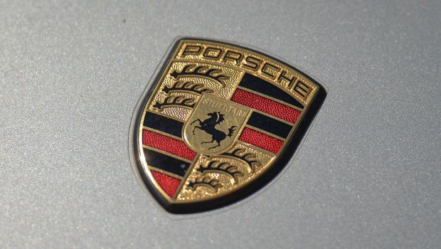 The Porsche logo on the hood of a parked car in South Edmonton, Alberta, Canada
