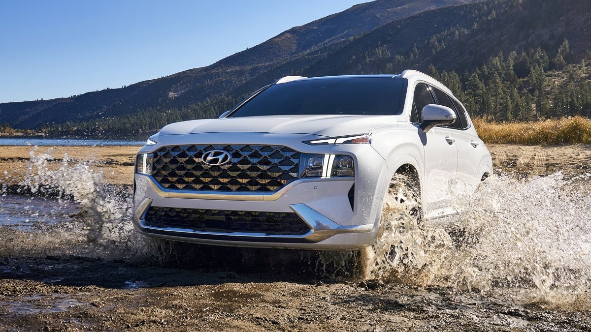 Quartz White 2022 Hyundai Santa Fe driving in muddy water