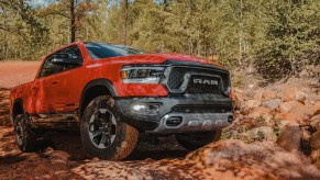 A red 2022 Ram 1500 navigates a rough terrain a full-size truck.