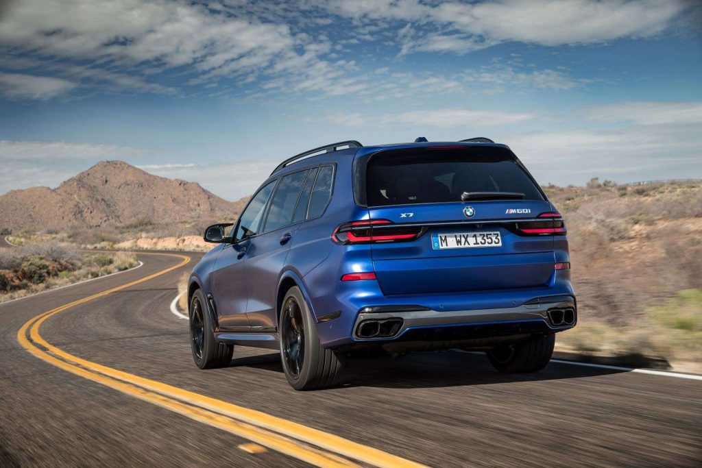 Rear angle view of blue 2023 BMW X7, highlighting its release date and price