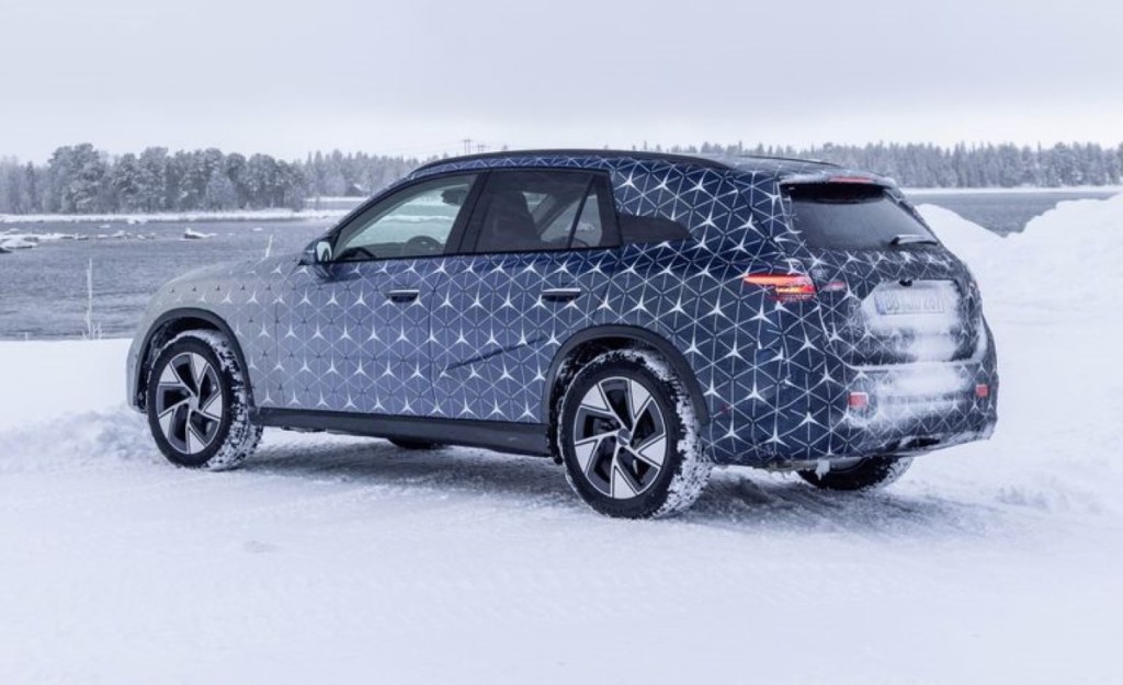 Rear angle view of camouflaged 2023 Mercedes-Benz GLC-Class, highlighting its release date and price