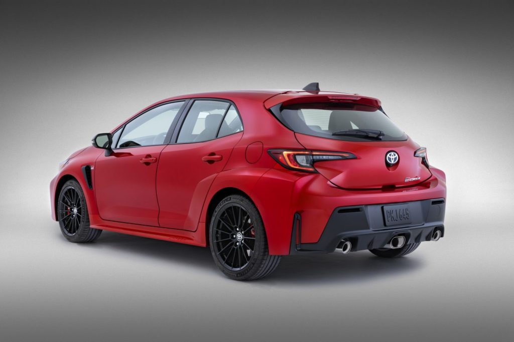 Rear angle view of red 2023 Toyota GR Corolla, highlighting its release date and price