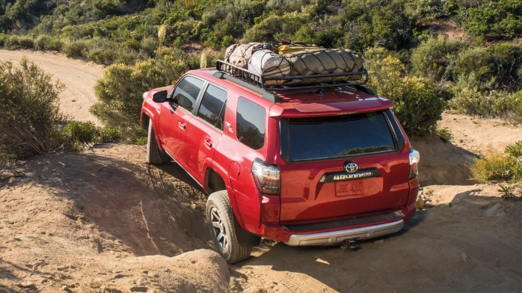Red 2022 Toyota 4Runner, the best SUV to buy for off-road use in 2022, driving on bumpy terrain