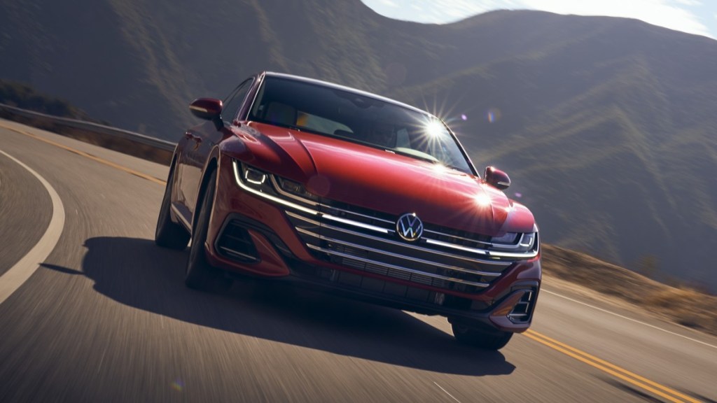 Red 2022 Volkswagen Arteon, one of the most underrated cars to buy in 2022, driving on a mountain road
