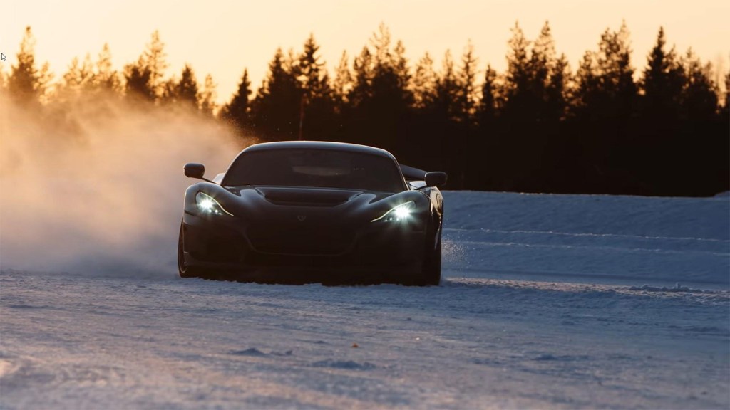 Front Rimac Nevera electric hypercar driving in the snow