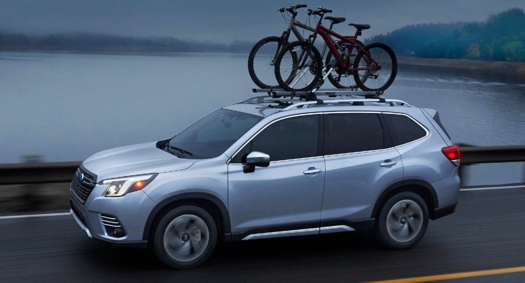 A gray 2022 Subaru Forester is driving down the road. 