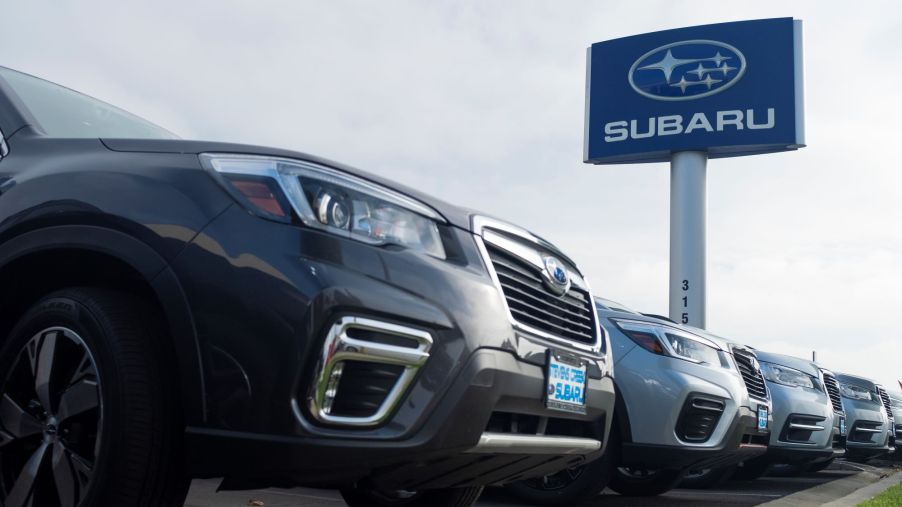 A row of Subaru vehicles with a Subaru sign.