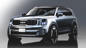 A rednering of a light gray 2023 Kia Telluride against a gray background