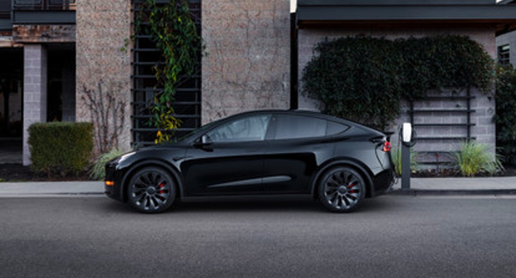 A black 2022 Tesla Model Y electric SUV is parked. 
