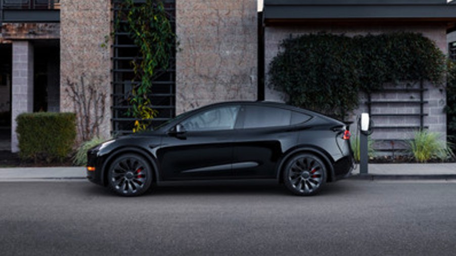 A black 2022 Tesla Model Y electric SUV is parked.