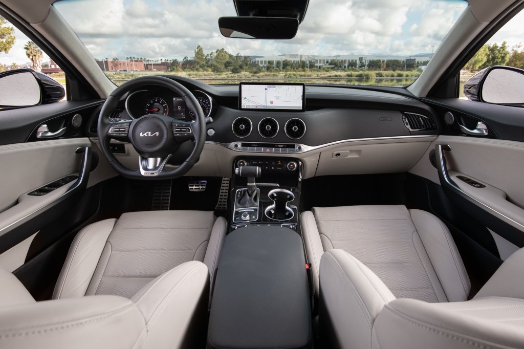 The white front seats and gray dashboard of a 2022 Kia Stinger GT-Line