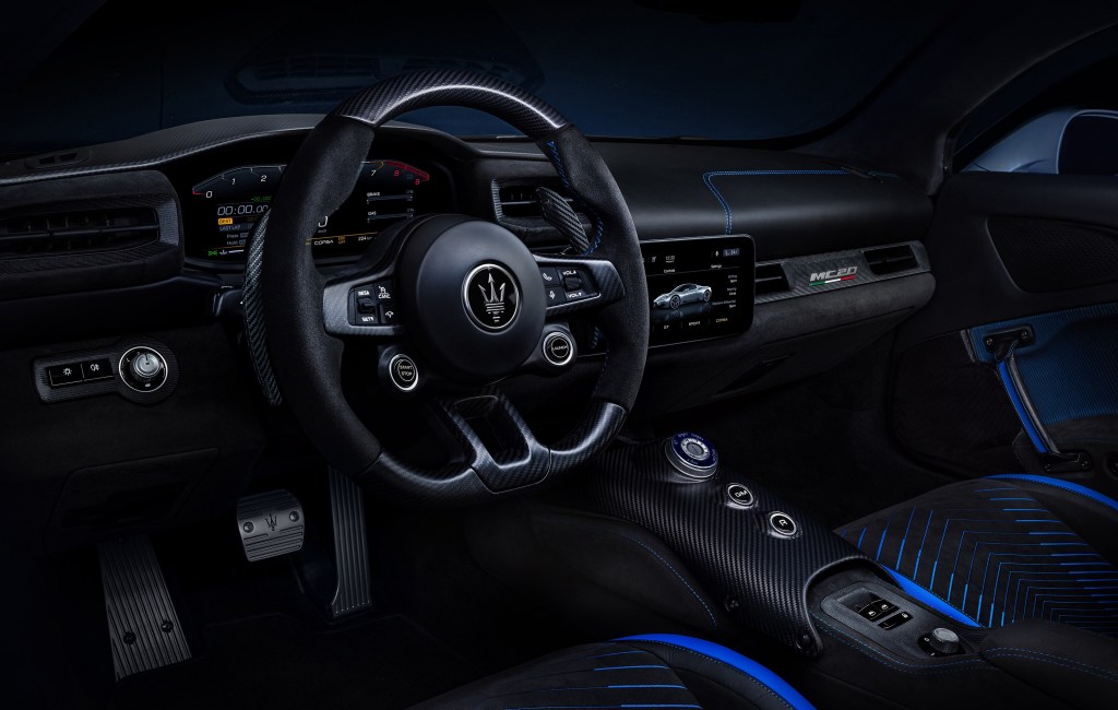 A 2022 Maserati MC20's black-and-blue Sabelt seats and dashboard