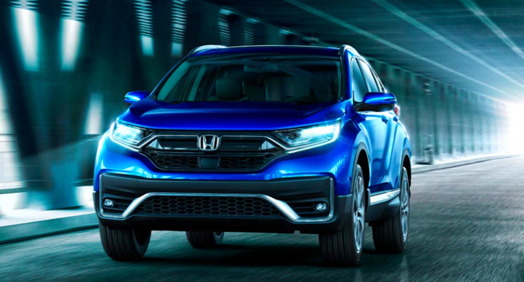 A blue 2022 Honda CR-V small SUV is driving on the road.