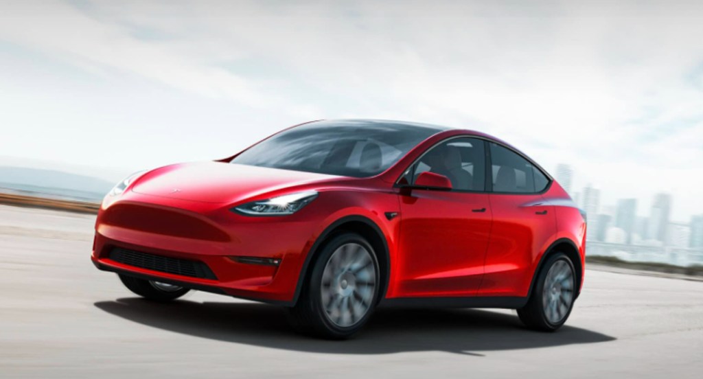 A red 2022 Tesla Model Y is driving.