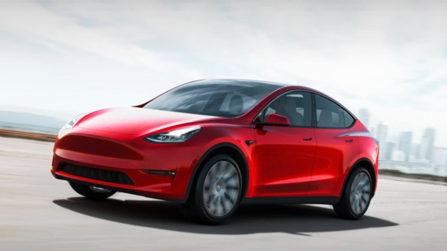 A red 2022 Tesla Model Y is driving.
