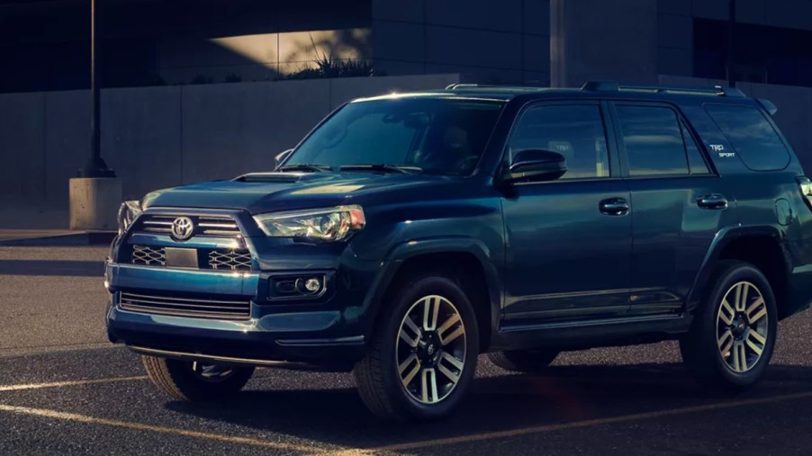 A blue 2022 Toyota 4Runner midsize SUV is driving on the road.