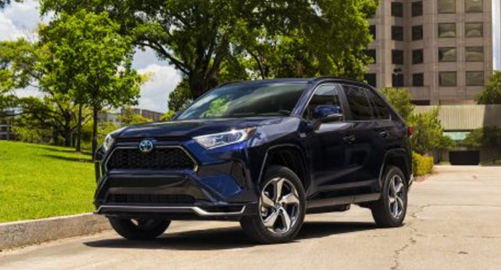 A blue Toyota RAV4 Prime small plug-in hybrid SUV is parked. 