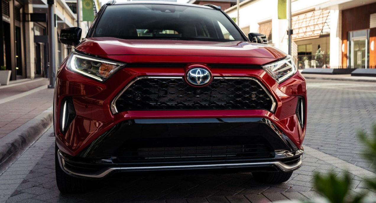 A red 2022 Toyota RAV4 Prime plug-in hybrid SUV is parked.