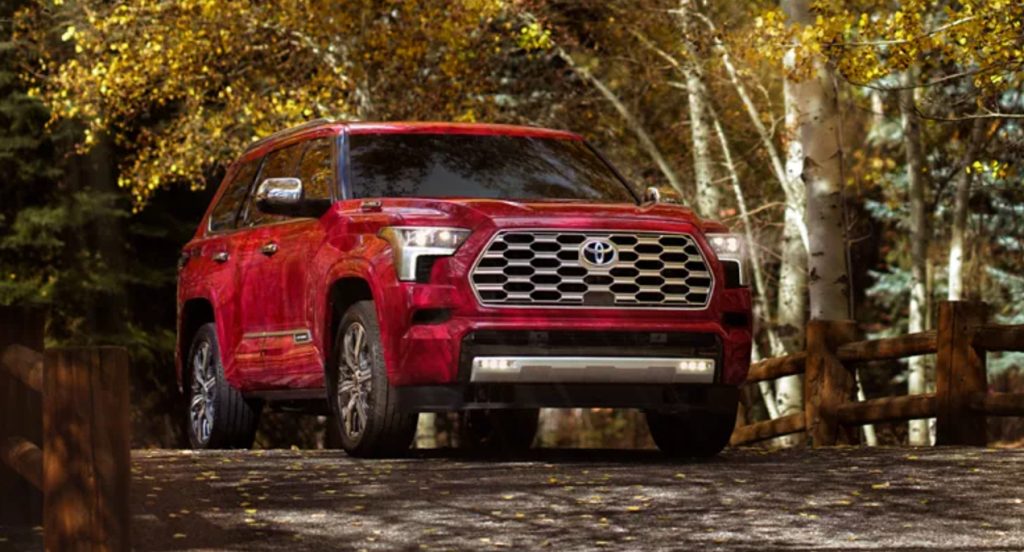 A red 2023 Toyota Sequoia midsize SUV is parked. 