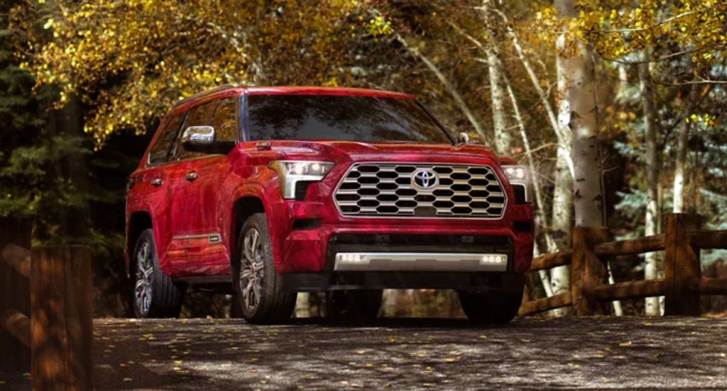 A red 2023 Toyota Sequoia midsize SUV is parked.