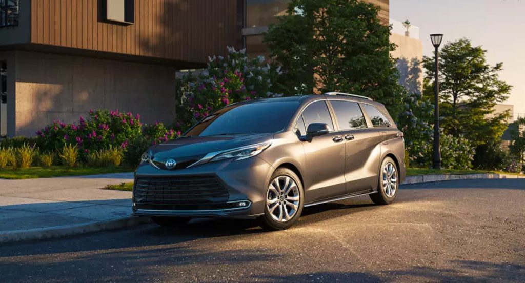 A gray 2022 Toyota SIenna is parked on the road.  van